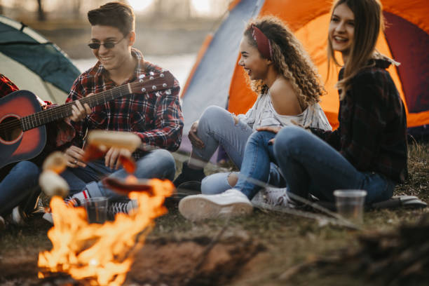 istock Friends camping by the river 1220718204