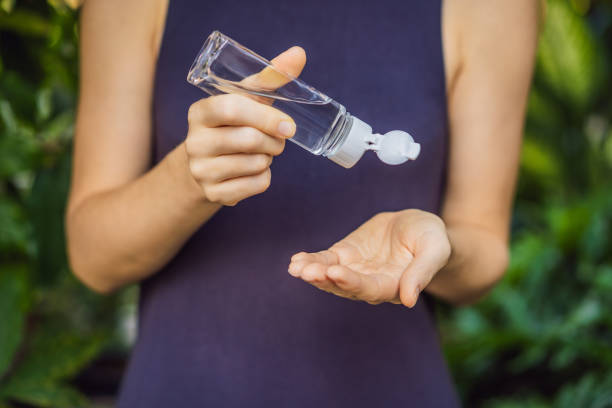 istock Women's hands using wash hand sanitizer gel 1220718528