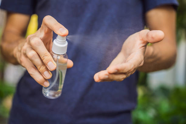 istock Men's hands using wash hand sanitizer gel 1220718542