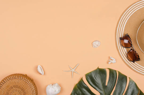 istock Summer straw hat, tropical monstera leaf, sunglasses, shells, starfish on yellow background. 1220720378