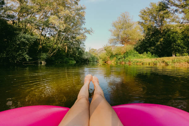 Photo of a young woman relaxing on inflatable ring in the river