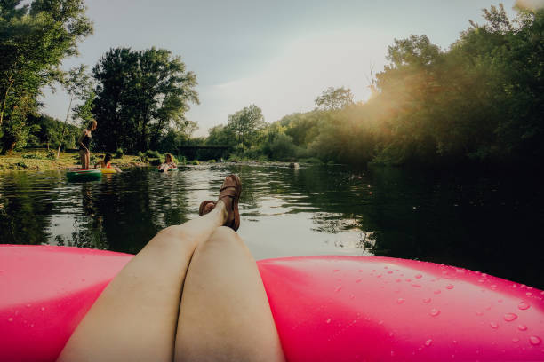 Photo of girlfriends relaxing on inflatable rings in the river