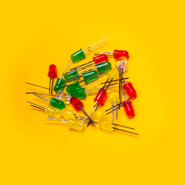 istock Red, blue, green or yellow transparent plastic electronic components over yellow 1220723060