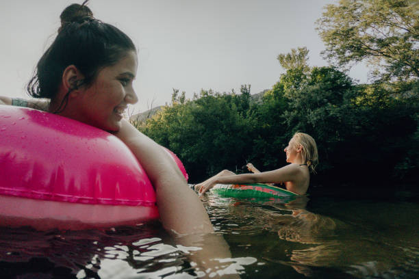 istock Relaxing on inflatable rings in the river 1220723151