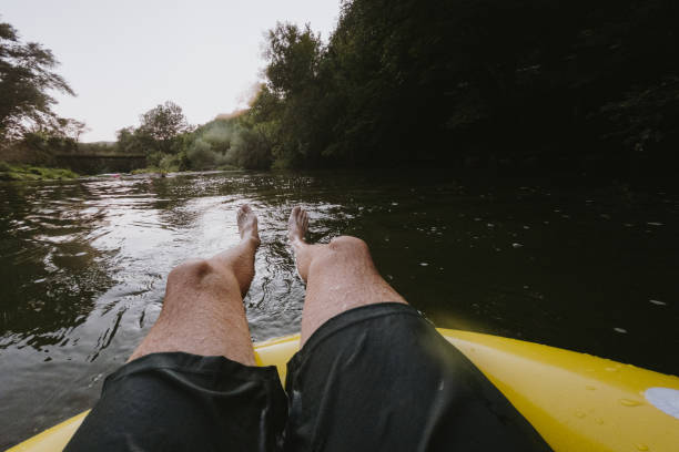 istock Young man relaxing on inflatable ring in the river 1220723160
