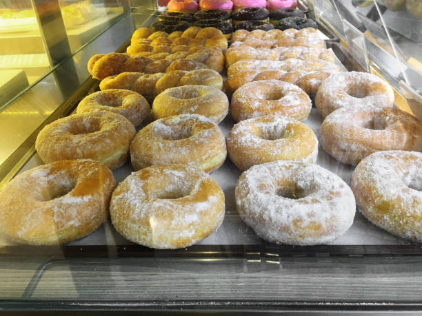 istock Group of sweet donuts on plastic tray in bakery shop 1220724914