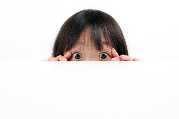 istock Little girl peeking over table 1220725528