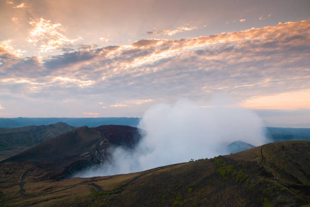 Volcano crater smoking at sunset in Nicaragua Volcano crater smoking at sunset in Nicaragua, mountain roads seen with people walking masaya volcano stock pictures, royalty-free photos & images