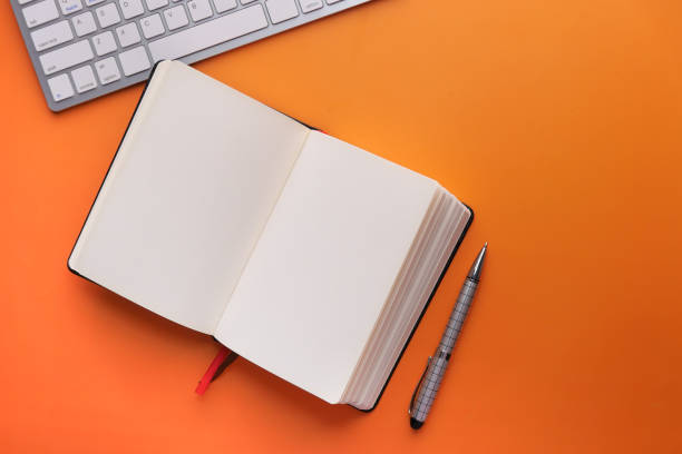istock high angle view of open diary pen and keyboard 1220727719