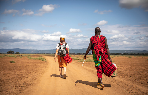 Same, Tanzania, 7th June, 2019: people walking on a dusty road in Maasai land in Tanzania