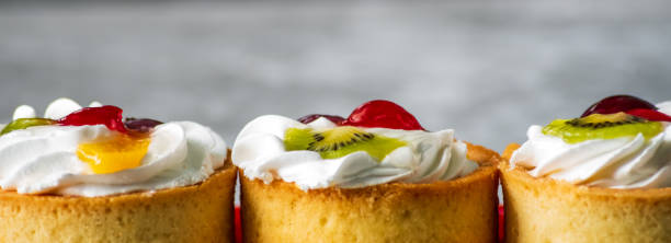 istock Cakes with whipped cream and slices of fruit 1220728729
