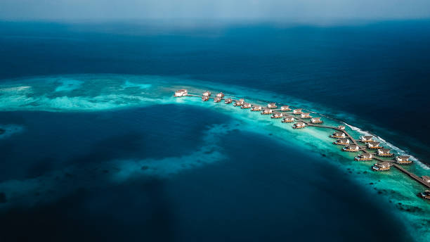 istock Maldives Island Lagoon with Over Water Villas 1220728817