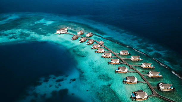 istock Maldives Island Lagoon with Over Water Villas 1220728829