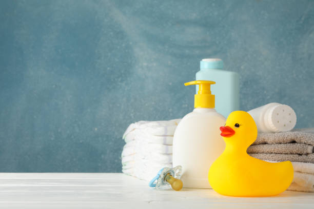 istock Baby hygiene accessories on wooden table against blue background 1220730179