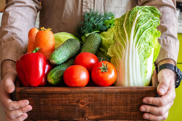 istock A farmer holds a box of fresh eco-friendly vegetables in his hands. 1220730618