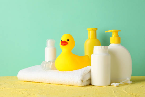 istock Baby hygiene accessories on yellow table against mint background 1220730776