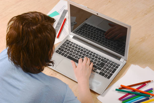 istock Woman with notebook working at floor in home isolation. Good for inserting your image on the screen. 1220731541