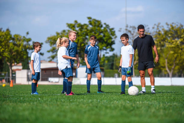 istock Coach and Young Footballers During Practice Session 1220731641
