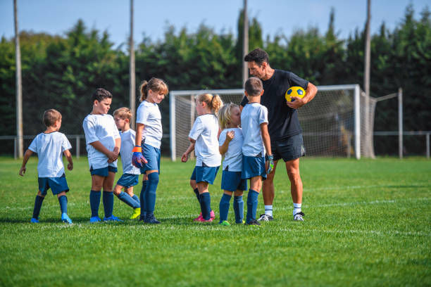 istock Mature Coach Working with Young Footballers 1220731652