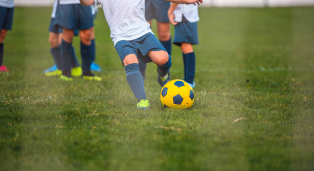istock Partial View of Young Boy Footballer Practicing Goal Kick 1220731661