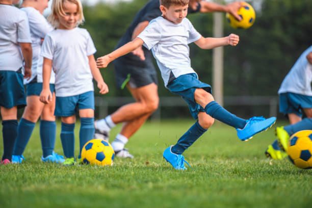 istock Young Boy Footballers Doing Kicking Drills with Coach 1220731670
