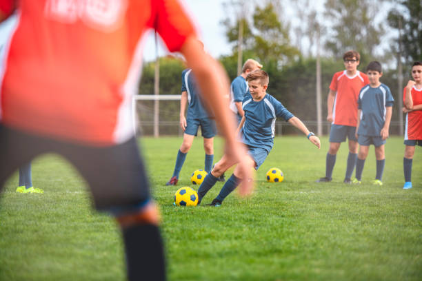 istock Blue Jersey Boy Footballer Practicing Goal Kick 1220731688