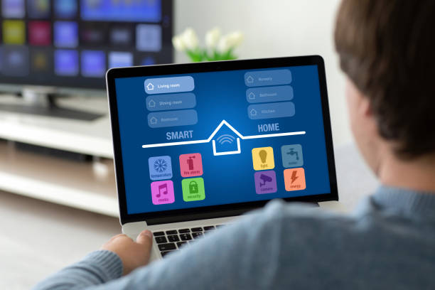 istock man holding laptop with app smart home on the screen 1220731951