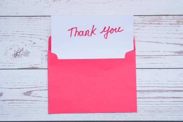 istock Close up of thank you message, envelope on white 1220732169