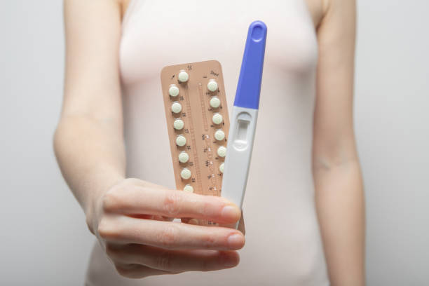 The girl holds a pregnancy test in her hands and birth control pills. Close-up The girl holds a pregnancy test in her hands and birth control pills. Close-up Ovulation stock pictures, royalty-free photos & images