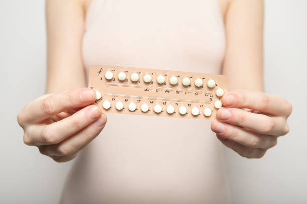 Girl holds birth control pills in her hands. Contraception Girl holds birth control pills in her hands. Contraception morning after pill stock pictures, royalty-free photos & images