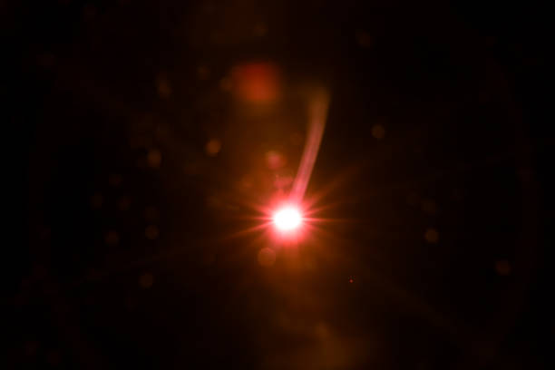 istock abstract lens flare red light over black 1220733285