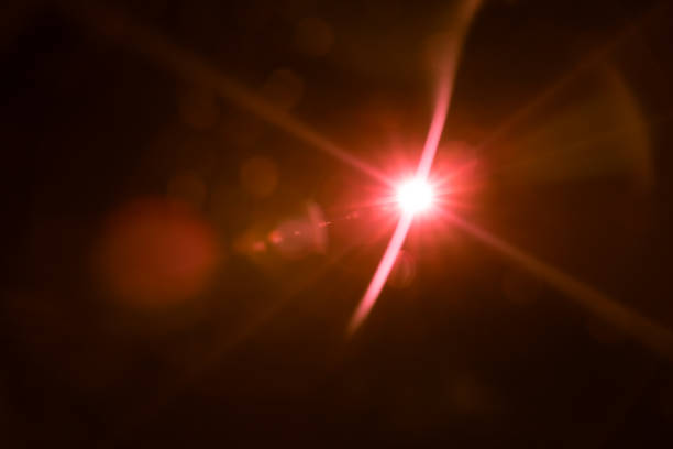 istock abstract lens flare red light over black 1220733333