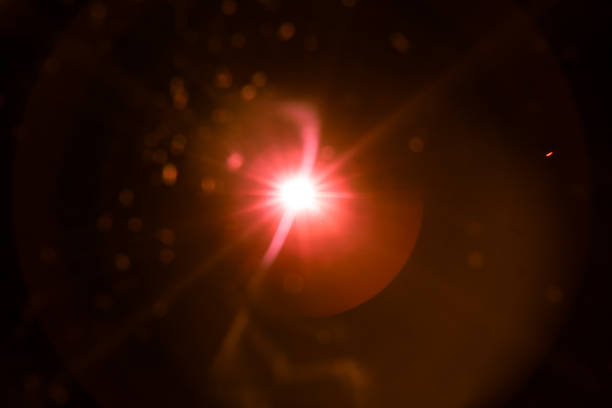 istock abstract lens flare red light over black 1220733368