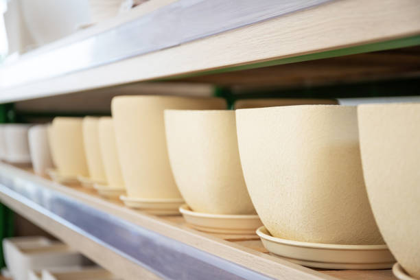 istock Ceramic flower pots on a rack in a store. gardening Tools 1220733643