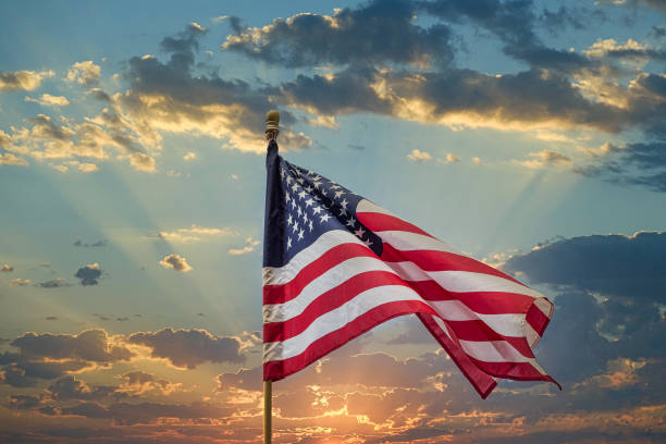 istock American Flag on Wood Pole Against Sunset 1220734793