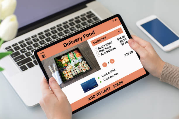 istock female hands holding tablet with app delivery food on screen 1220734853
