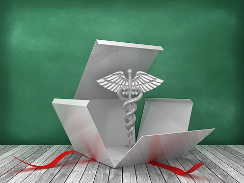 Gift Box with Caduceus Symbol on Chalkboard Background - 3D Rendering