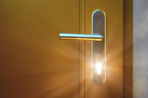 istock Light shining through a keyhole of a door 1220735577