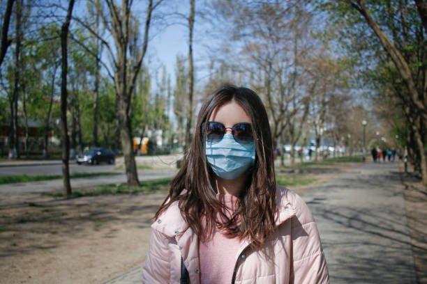 istock girl in medical mask 1220735652