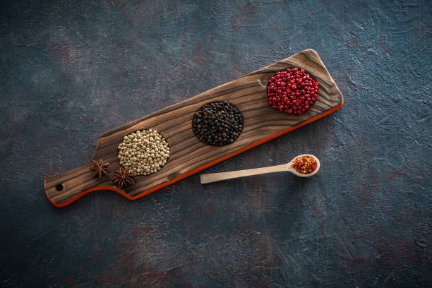 Spices black white and red pepper on rustic grunge gray table background