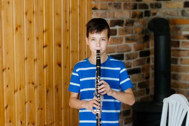 istock Boy with a clarinet plays music. Online music lesson concept 1220736483