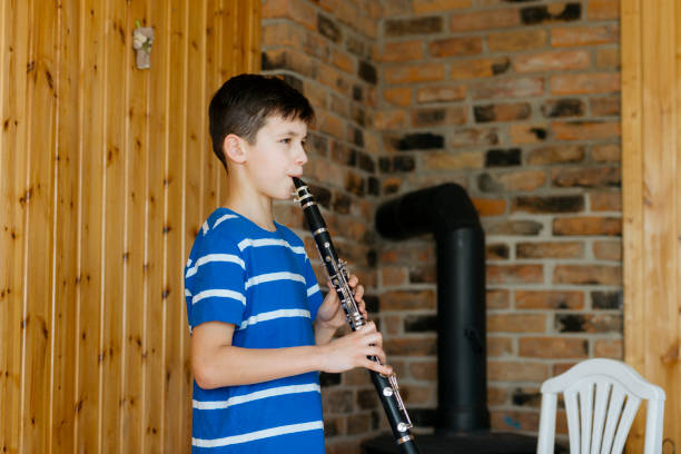 istock Boy with a clarinet plays music. Online music lesson concept 1220736601