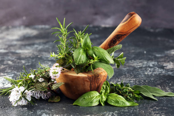 istock Homegrown and aromatic herbs on rustic background with rosemary and basil 1220737781