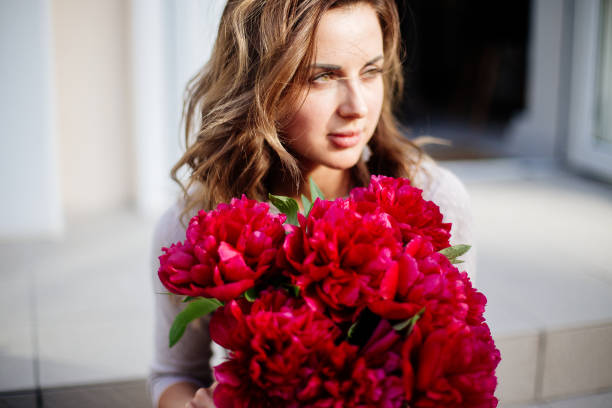 istock Bouquet of peonies in hands 1220738596