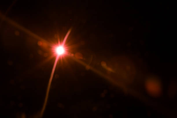 istock abstract lens flare red light over black 1220738732