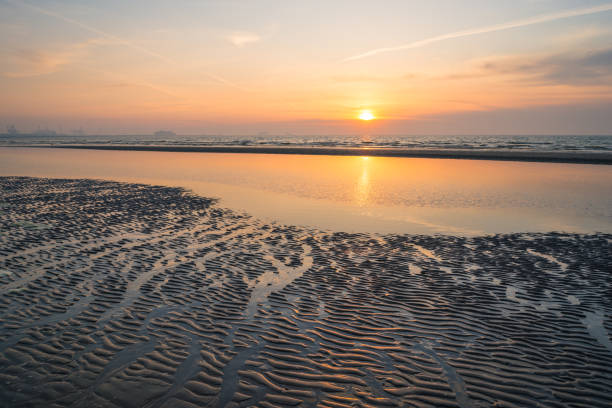 istock Sun sets behind a cloud bank over sea 1220738917