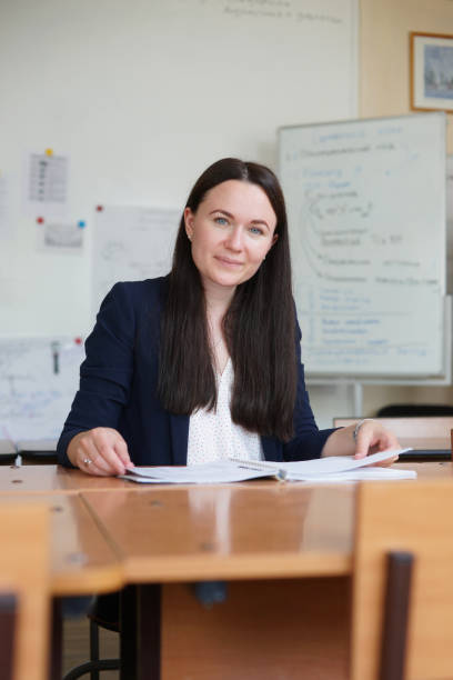 istock Beautiful female teacher in classroom 1220741159