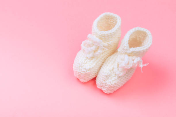 istock knitted baby booties on pastel pink background - Image 1220742466
