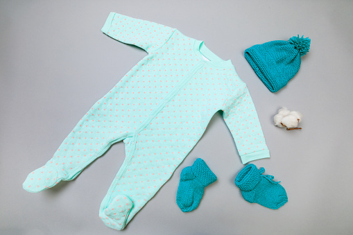 Baby concept. Baby cloth and goods on grey  background. Place for text. View from above. Flat Lay