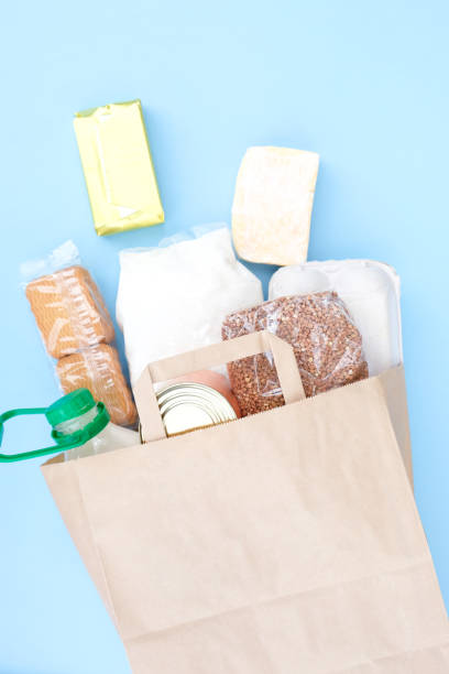 istock Food donations on blue background, top view with copy space 1220743216